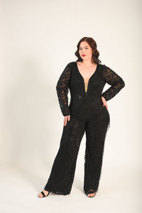 Beaded jumpsuit, with sheer sleeves. Sheer panel along the bust line. V-neckline. Back zipper. 