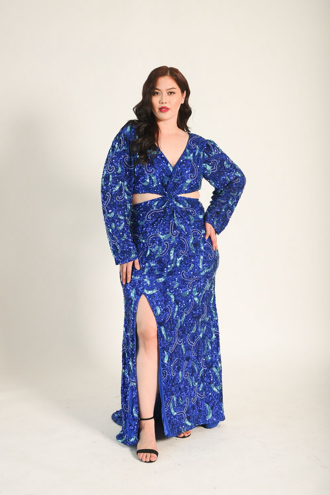 Beaded sequin fabric. Criss cross wrap style at the middle of the bodice. Cut out  from the bodice to the back of the gown. Zipper at the back of the top of the dress and lower back of the dress. High split. 