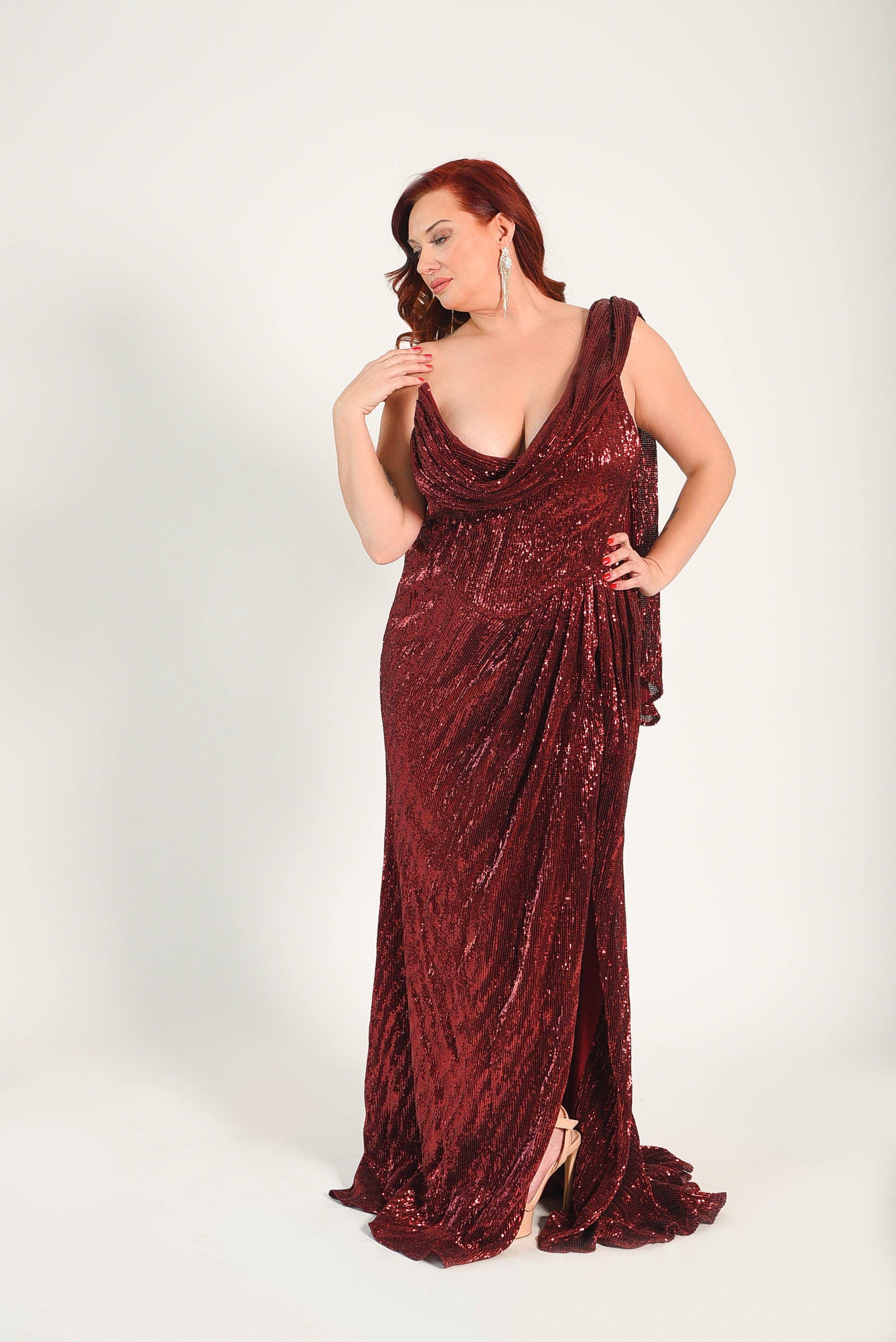 Beaded sequin gown, with a high split. Boning built into the bodice of the gown. High point along the bust. 