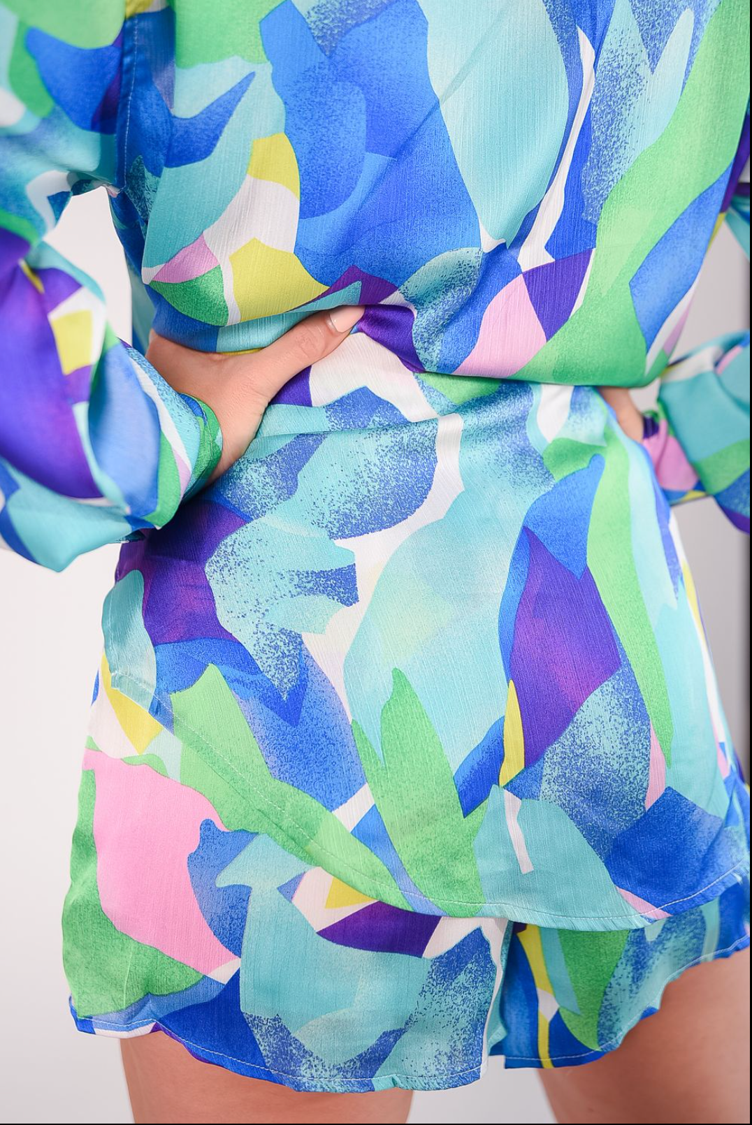 multicolored geometric satin fabric matching shit and shorts set. With button down style shirt and drawstring shorts detail
