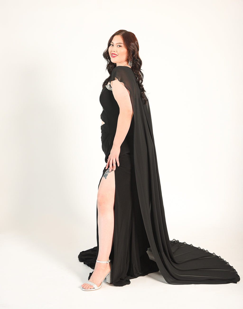Strapless gown with crystal beaded accents. Cutouts in the front and back. High Split. Side zipper. 