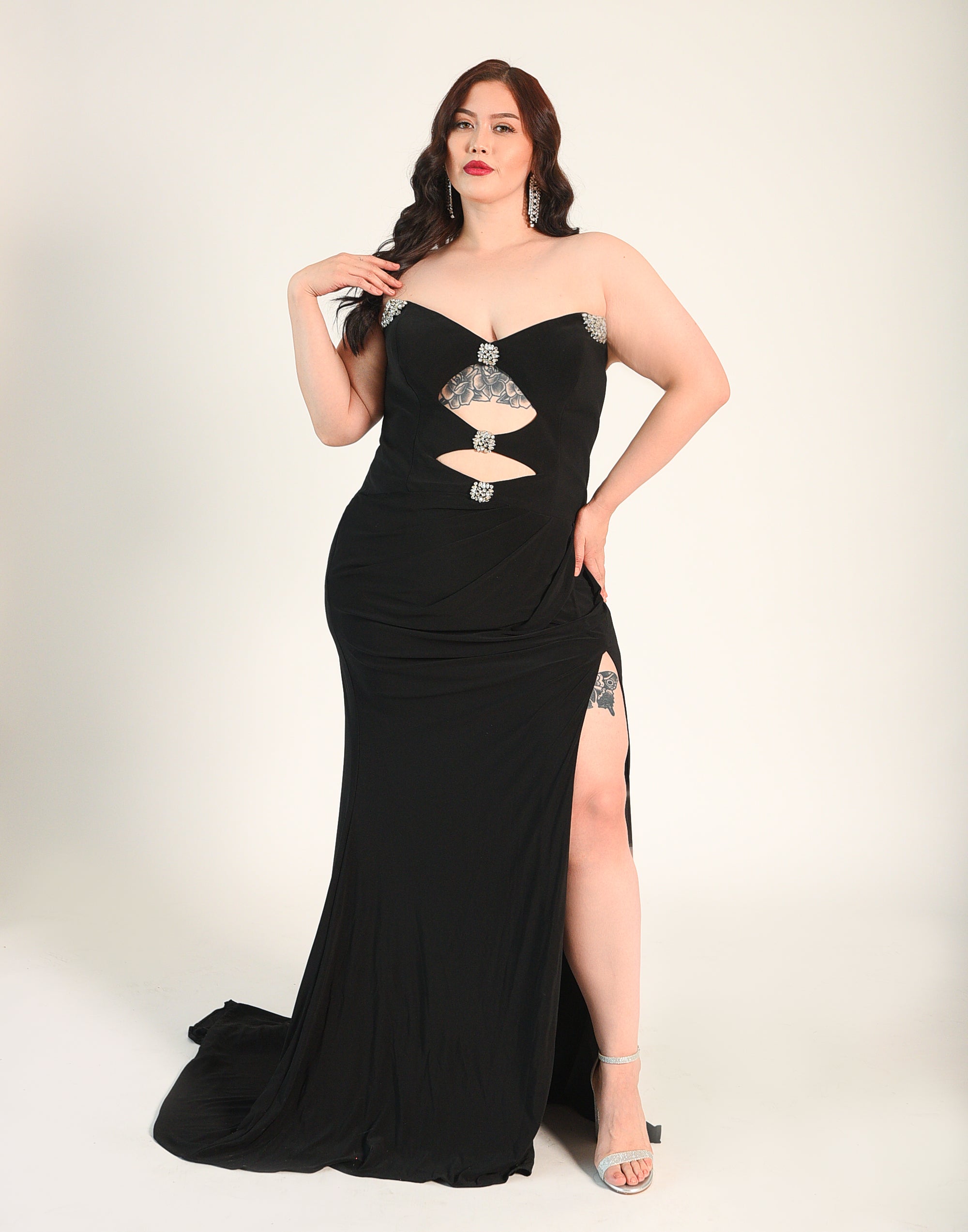 Strapless gown with crystal beaded accents. Cutouts in the front and back. High Split. Side zipper. 