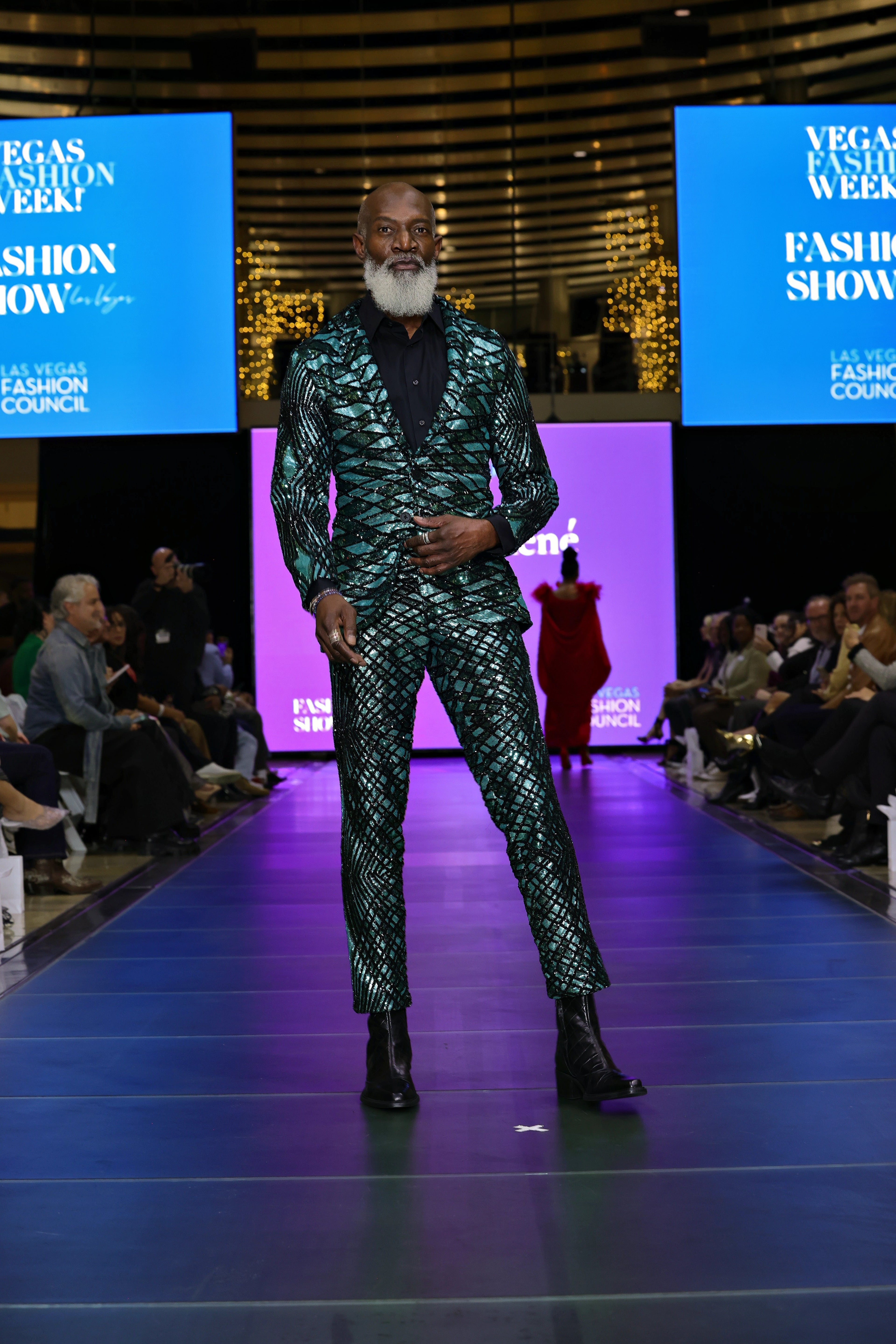 Man in a patterned suit standing on a runway