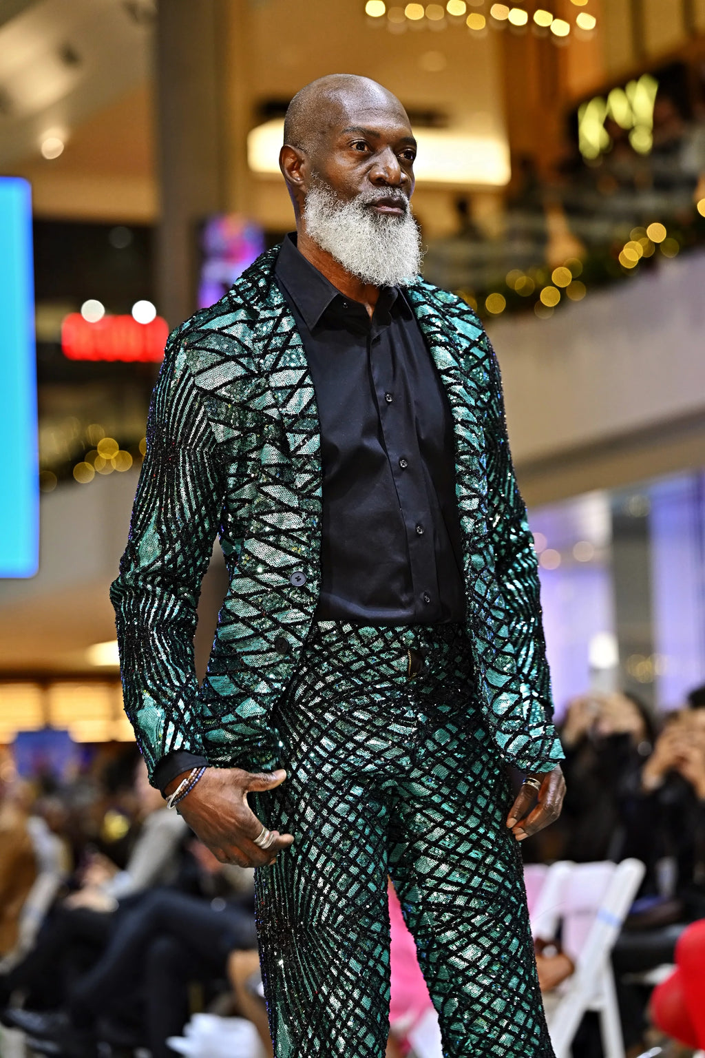 A man wearing a patterned outfit on a fashion runway