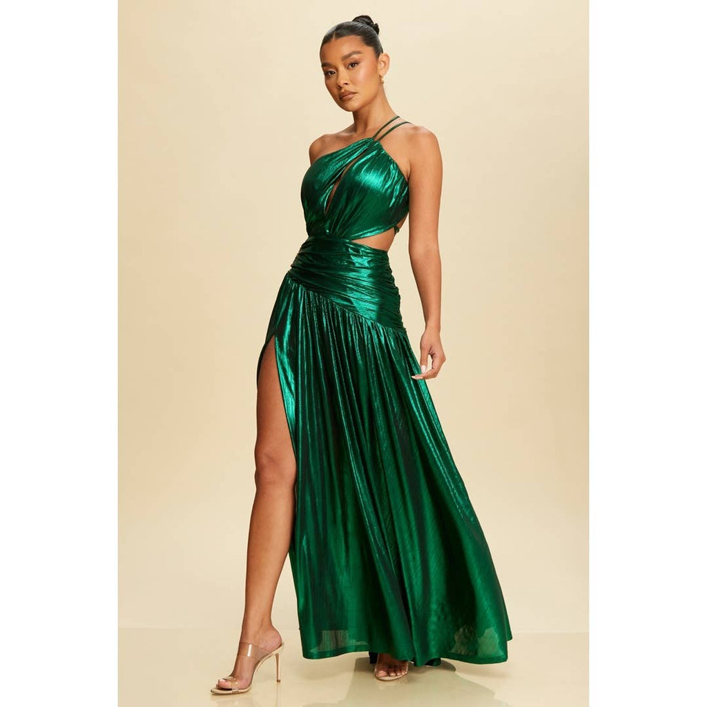 Woman wearing a green metallic dress with a slit on a beige background