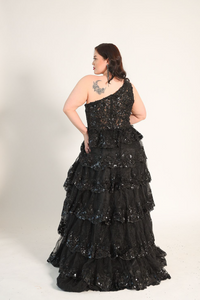 One shoulder gown, with a full skirt. Cacading tiered ruffles. Split on the left side. Back zipper. 