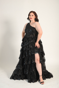 One shoulder gown, with a full skirt. Cacading tiered ruffles. Split on the left side. Back zipper. 