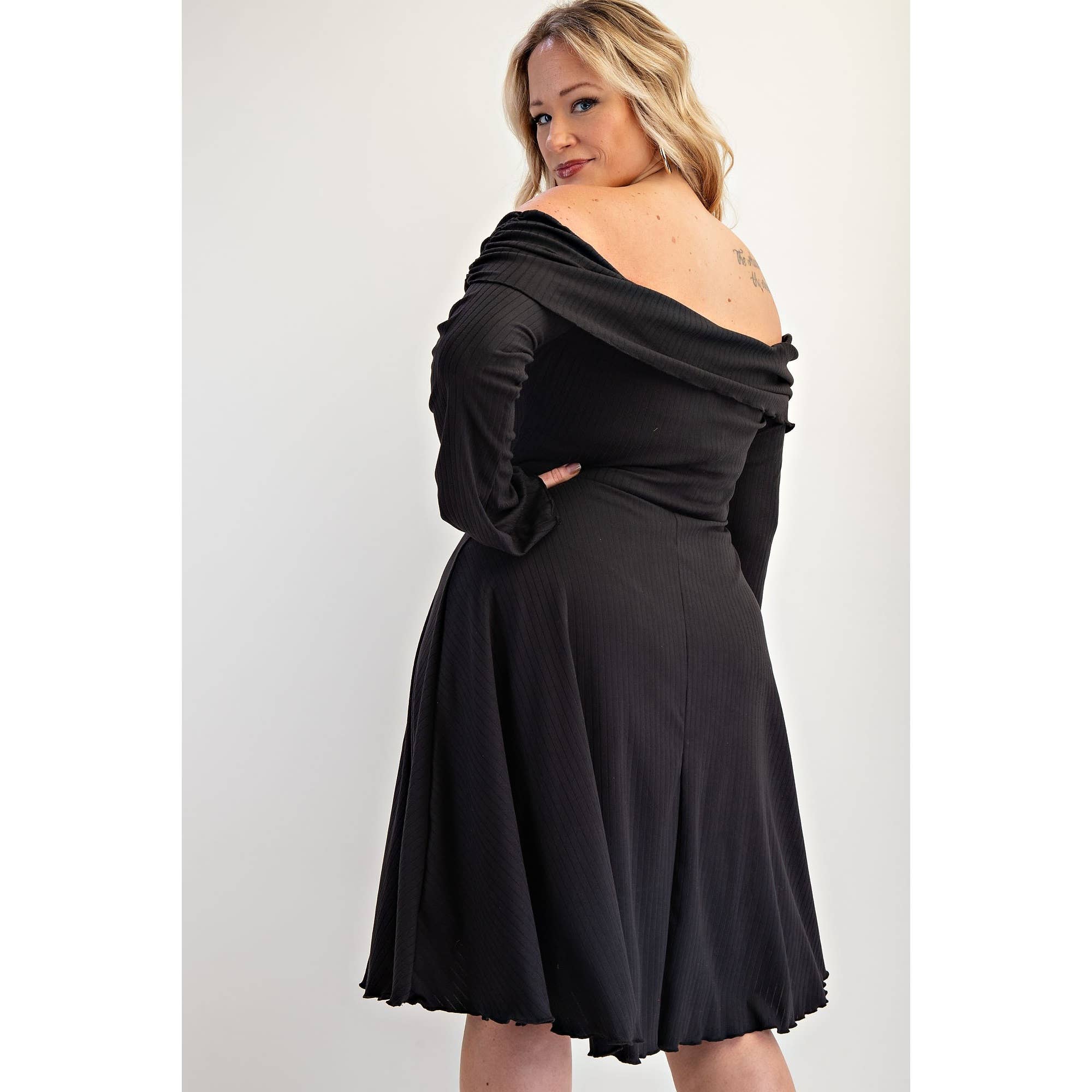 Woman wearing a black off-shoulder dress-  back view 