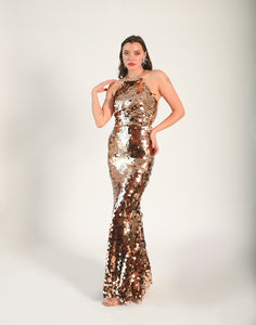 Sequin disc gown, with an open back. Beaded material along the straps at the neck and the back of the gown. Low zipper in the back. 