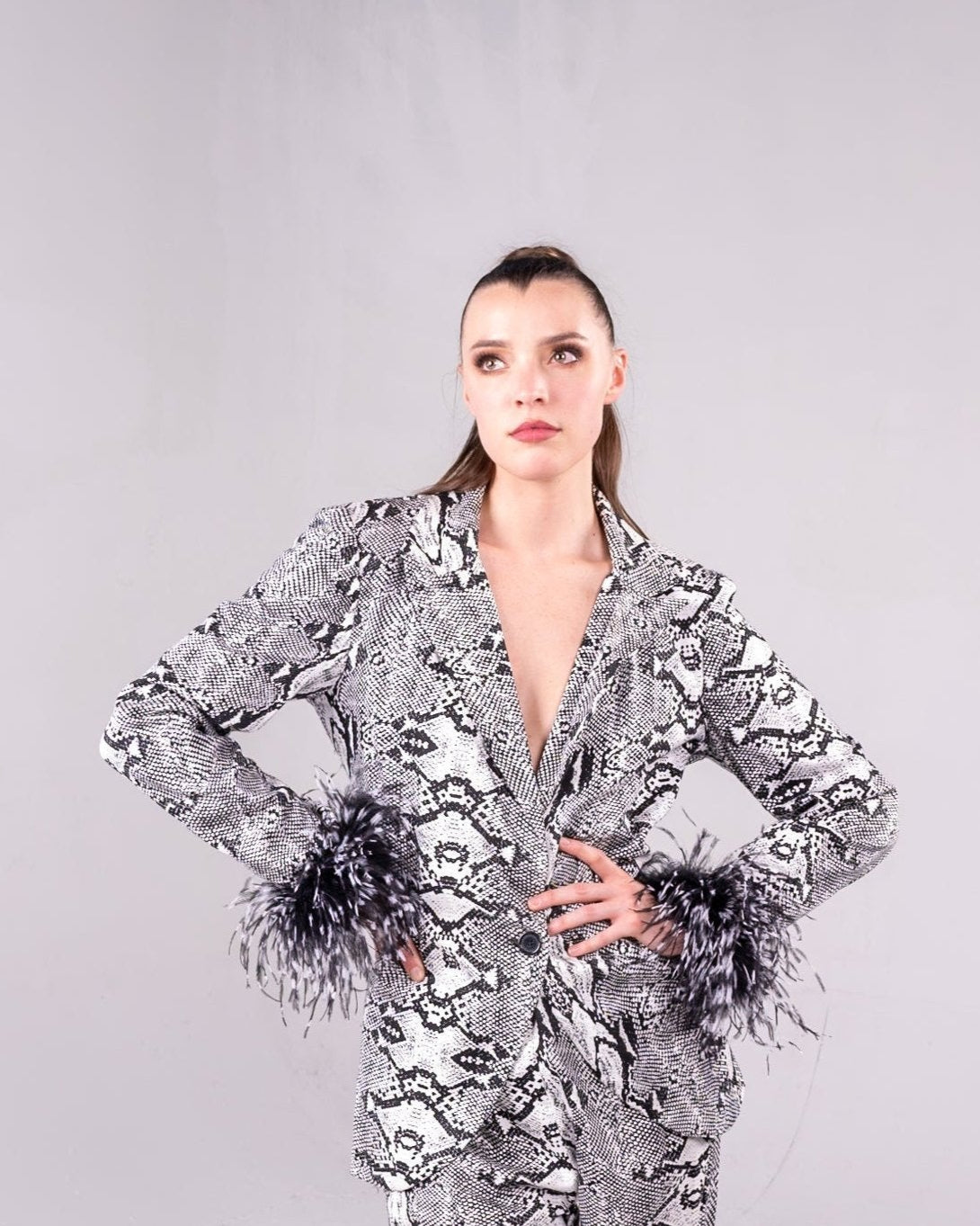 black and white snakeskin print suit with black and white feathers on the cuffs