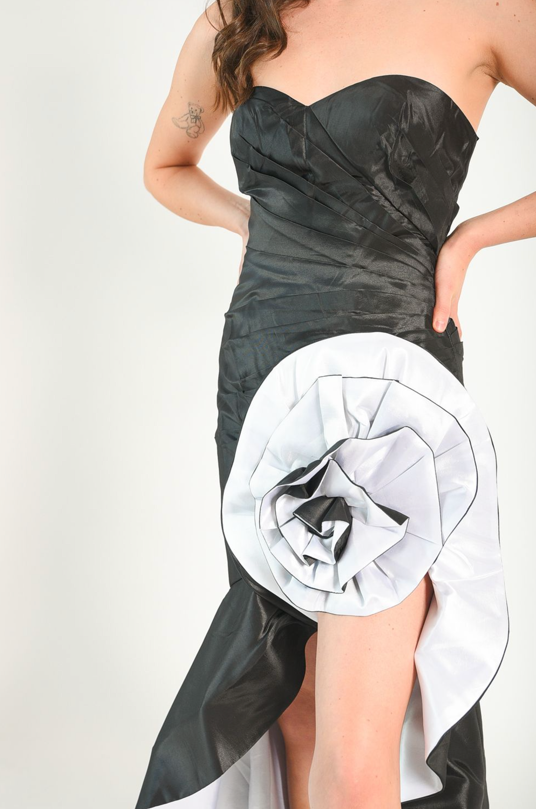 Strapless ruched gown with satin rosette detail. Zipper back. 
