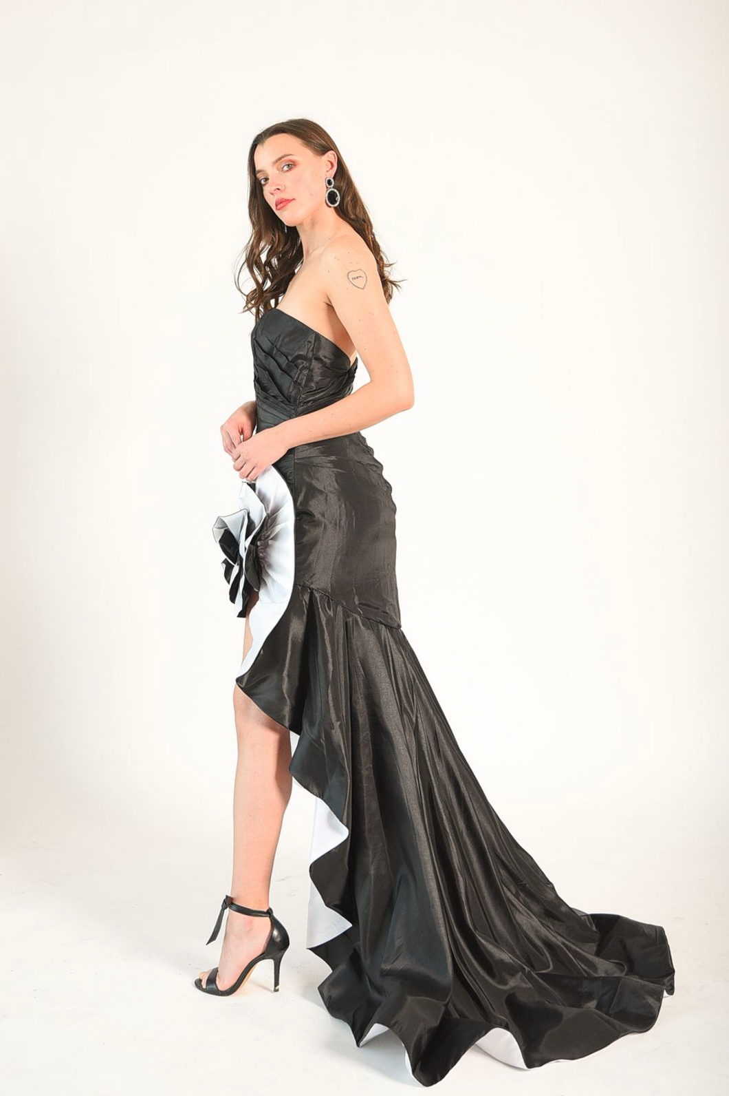 Strapless ruched gown with satin rosette detail. Zipper back. 